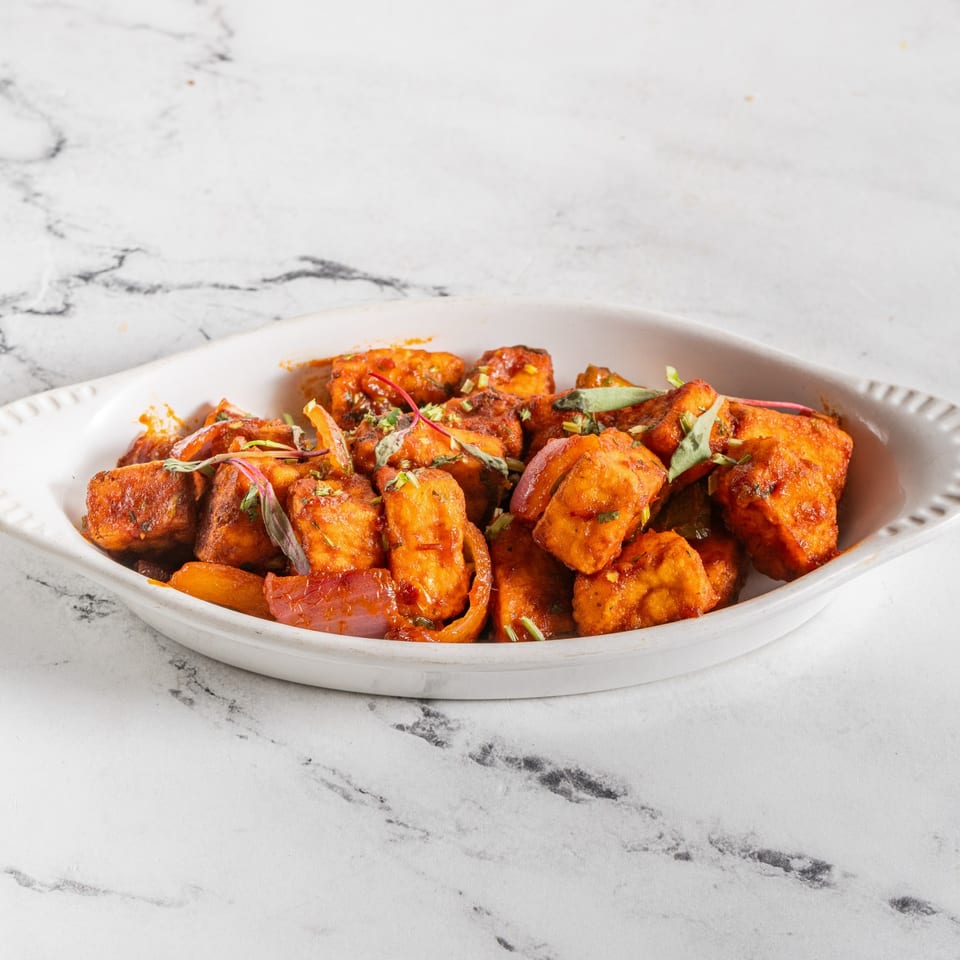 Raag Indian Cuisine's paneer chili, a dish of fried paneer cubes in a spicy red sauce.